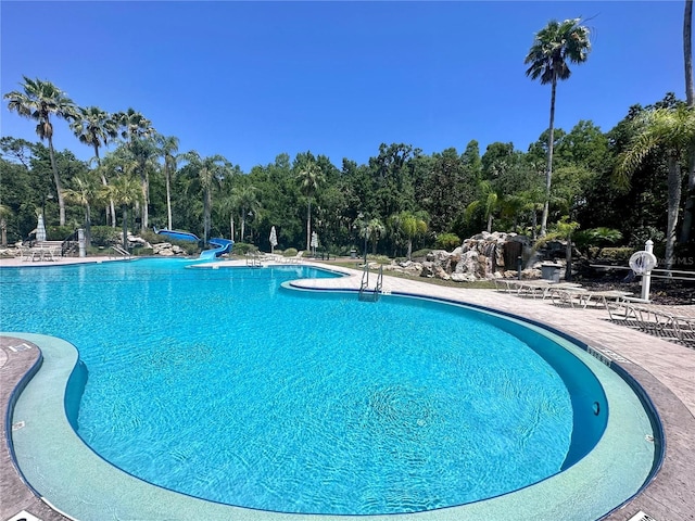 16206 Nottingham Park Way, Tampa, FL 33647 - community pool featuring a water slide, a patio, and view of scattered trees