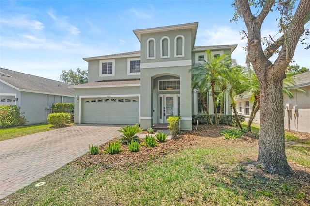 16206 Nottingham Park Way, Tampa, FL 33647 - view of front of house featuring stucco siding, decorative driveway, and a garage