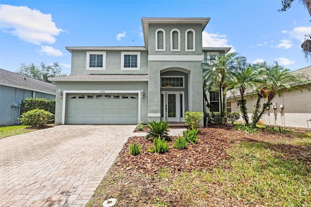 16206 Nottingham Park Way, Tampa, FL 33647 - view of front of property with stucco siding, decorative driveway, and an attached garage