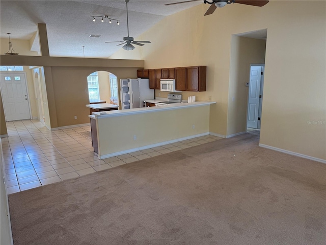 kitchen featuring white appliances, ceiling fan, light tile patterned floors, a textured ceiling, and light countertops
