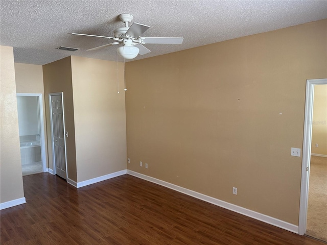 unfurnished room with wood finished floors, ceiling fan, baseboards, and a textured ceiling