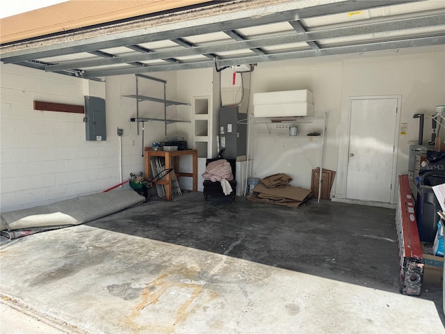 garage featuring electric panel and concrete block wall