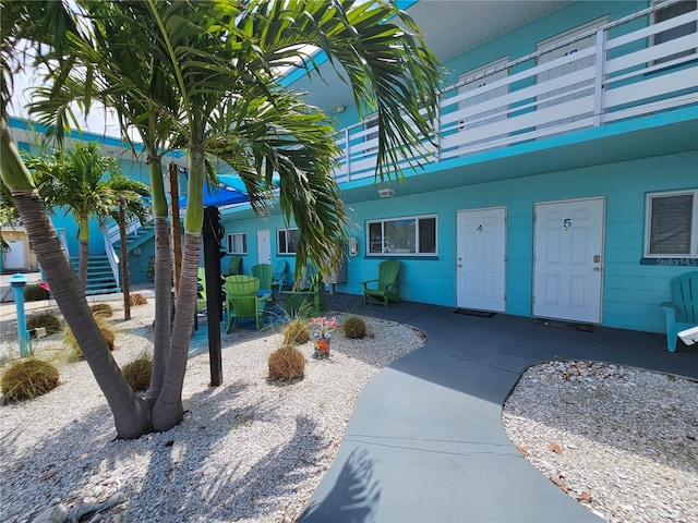 view of exterior entry with a patio area