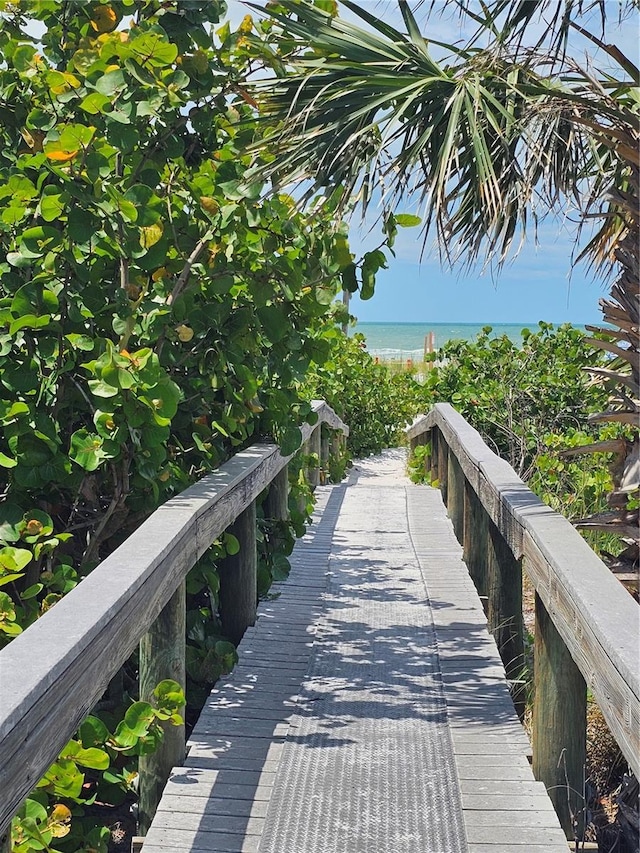 view of property's community with view of water and beach
