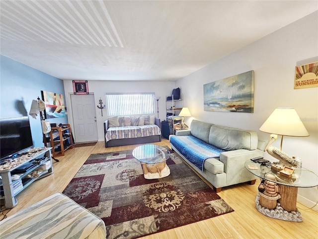 living area with wood finished floors and baseboards