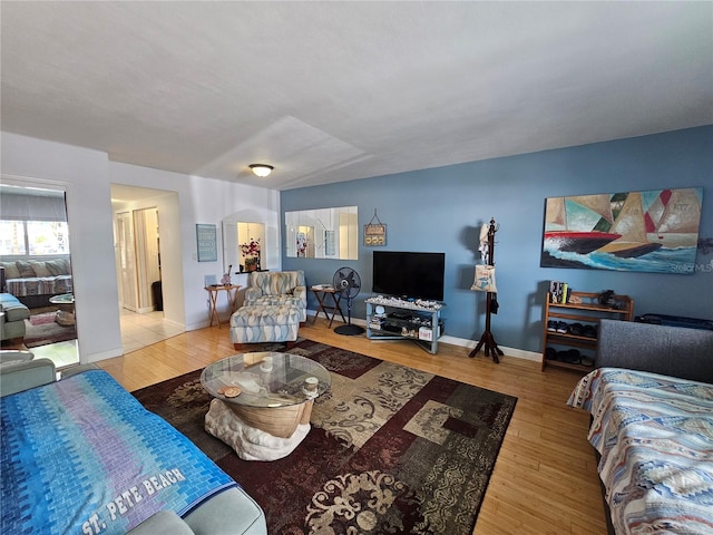 living area with wood finished floors and baseboards
