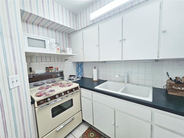 kitchen with white appliances, a sink, tasteful backsplash, open shelves, and white cabinetry