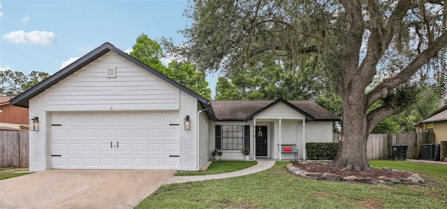 ranch-style house featuring an attached garage, driveway, brick siding, and central air condition unit
