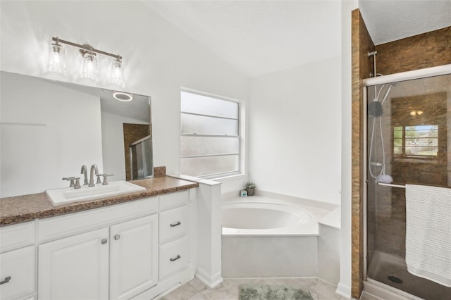 full bathroom featuring a stall shower, vanity, a garden tub, vaulted ceiling, and tile patterned floors