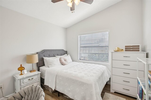 bedroom with lofted ceiling, wood finished floors, and ceiling fan