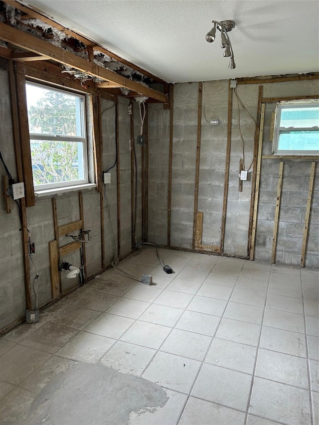 844 Bruce Ave, Clearwater Beach, FL 33767 - basement featuring a textured ceiling and concrete block wall