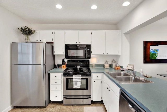 1390 Oak Hill Dr Unit 206, Dunedin, FL 34698 - kitchen featuring stainless steel appliances, a sink, white cabinetry, and recessed lighting