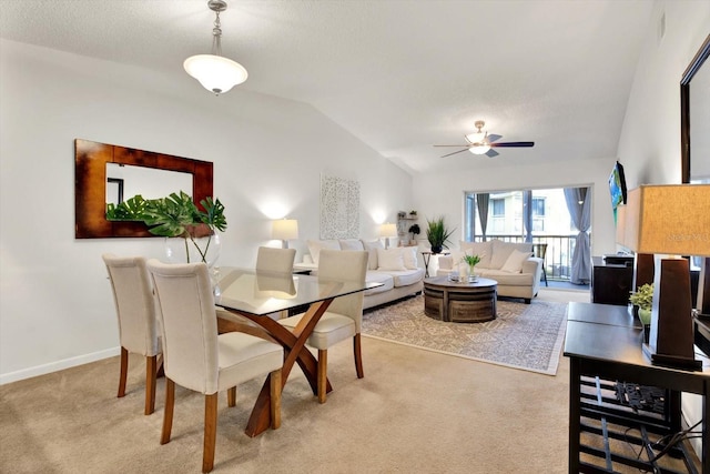 1390 Oak Hill Dr Unit 206, Dunedin, FL 34698 - dining room with lofted ceiling, light carpet, a ceiling fan, and baseboards