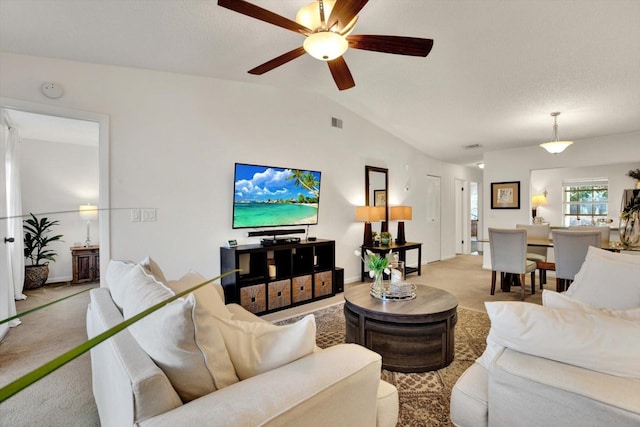 1390 Oak Hill Dr Unit 206, Dunedin, FL 34698 - living room with light carpet, vaulted ceiling, and a ceiling fan