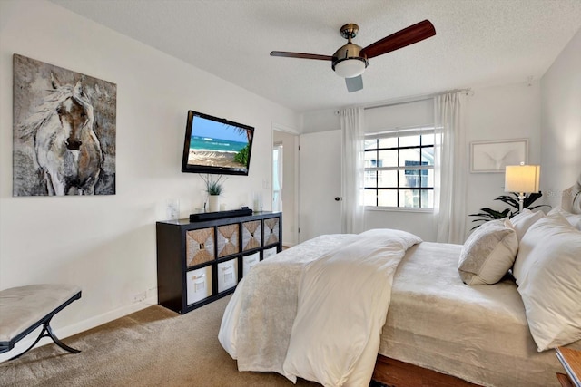 1390 Oak Hill Dr Unit 206, Dunedin, FL 34698 - bedroom with carpet floors, a textured ceiling, baseboards, and a ceiling fan
