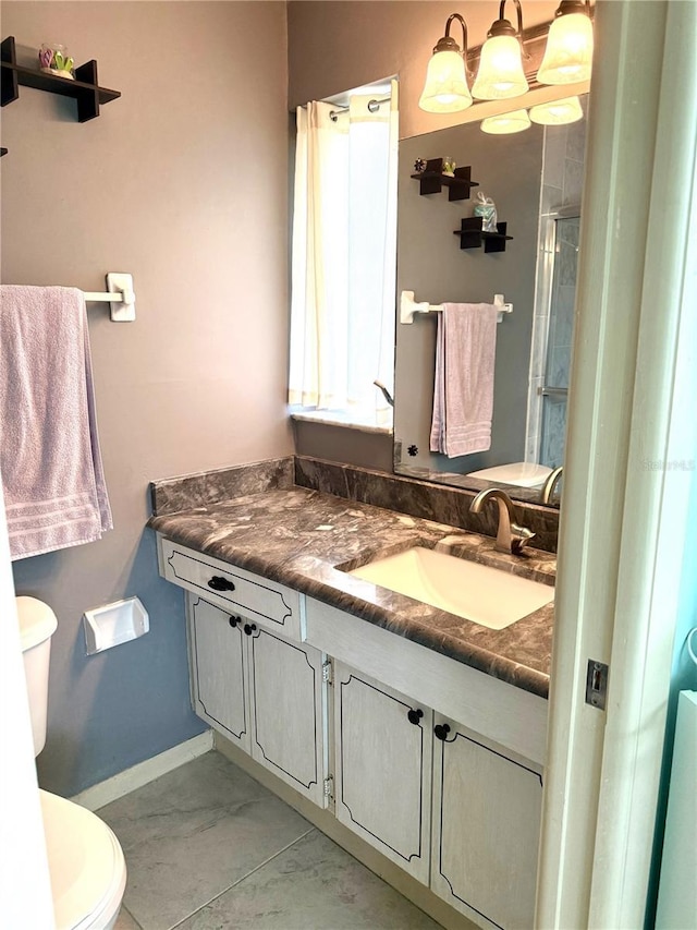 6880 Versailles N, Pinellas Park, FL 33781 - bathroom featuring toilet, vanity, baseboards, and an enclosed shower