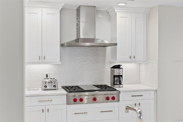 300 Beach Dr NE Unit 401, Saint Petersburg, FL 33701 - kitchen with wall chimney exhaust hood, stainless steel gas cooktop, decorative backsplash, and white cabinetry