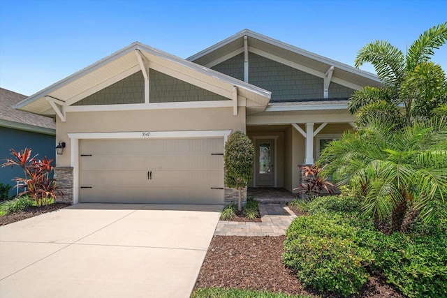 5547 Silver Sun Dr, Apollo Beach, FL 33572 - craftsman-style house with stucco siding, an attached garage, concrete driveway, and stone siding