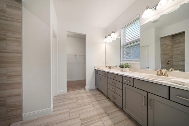 5547 Silver Sun Dr, Apollo Beach, FL 33572 - full bath featuring double vanity, baseboards, a spacious closet, and tiled shower