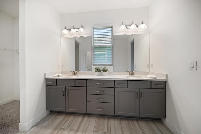 5547 Silver Sun Dr, Apollo Beach, FL 33572 - full bath featuring double vanity, baseboards, wood finished floors, and a walk in closet