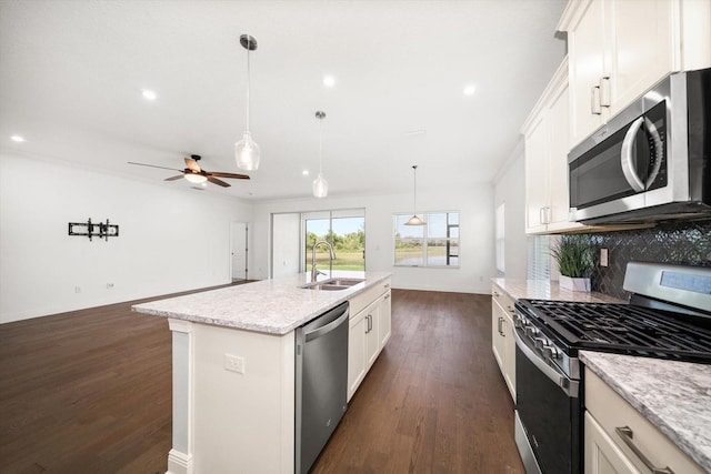 5547 Silver Sun Dr, Apollo Beach, FL 33572 - kitchen with appliances with stainless steel finishes, a sink, dark wood-type flooring, decorative backsplash, and baseboards