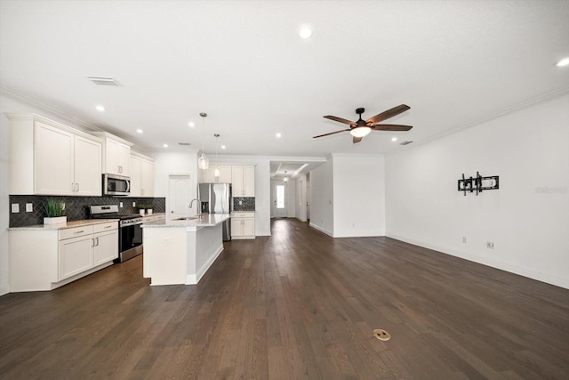 5547 Silver Sun Dr, Apollo Beach, FL 33572 - kitchen with stainless steel appliances, open floor plan, crown molding, a sink, and decorative backsplash