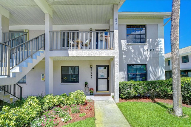 2139 Elm St Unit 308, Dunedin, FL 34698 - view of front of house with stucco siding and stairs