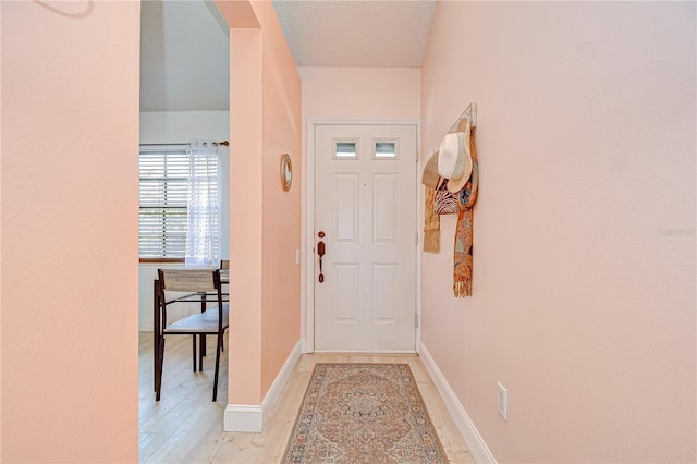 2139 Elm St Unit 308, Dunedin, FL 34698 - entryway with light wood-style flooring, baseboards, and arched walkways