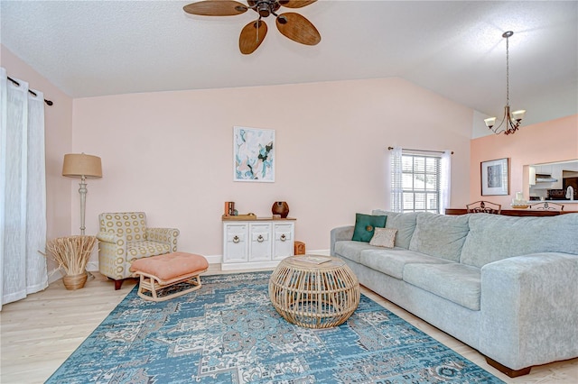2139 Elm St Unit 308, Dunedin, FL 34698 - living room with lofted ceiling, wood finished floors, ceiling fan, a chandelier, and baseboards