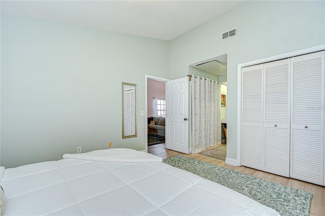 2139 Elm St Unit 308, Dunedin, FL 34698 - bedroom featuring wood finished floors, lofted ceiling, and a closet