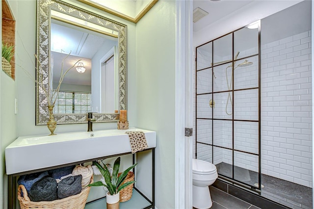 2139 Elm St Unit 308, Dunedin, FL 34698 - bathroom featuring toilet, a stall shower, and tile patterned flooring