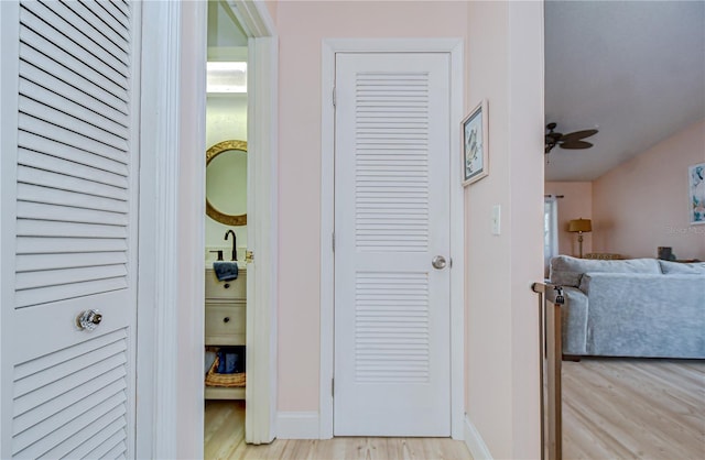 2139 Elm St Unit 308, Dunedin, FL 34698 - hallway with light wood-type flooring, a sink, and baseboards