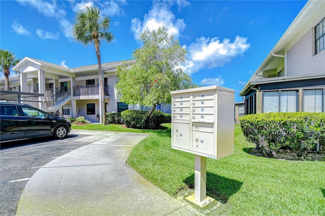 2139 Elm St Unit 308, Dunedin, FL 34698 - surrounding community featuring mail area, uncovered parking, and a lawn