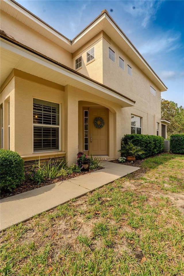 entrance to property featuring stucco siding