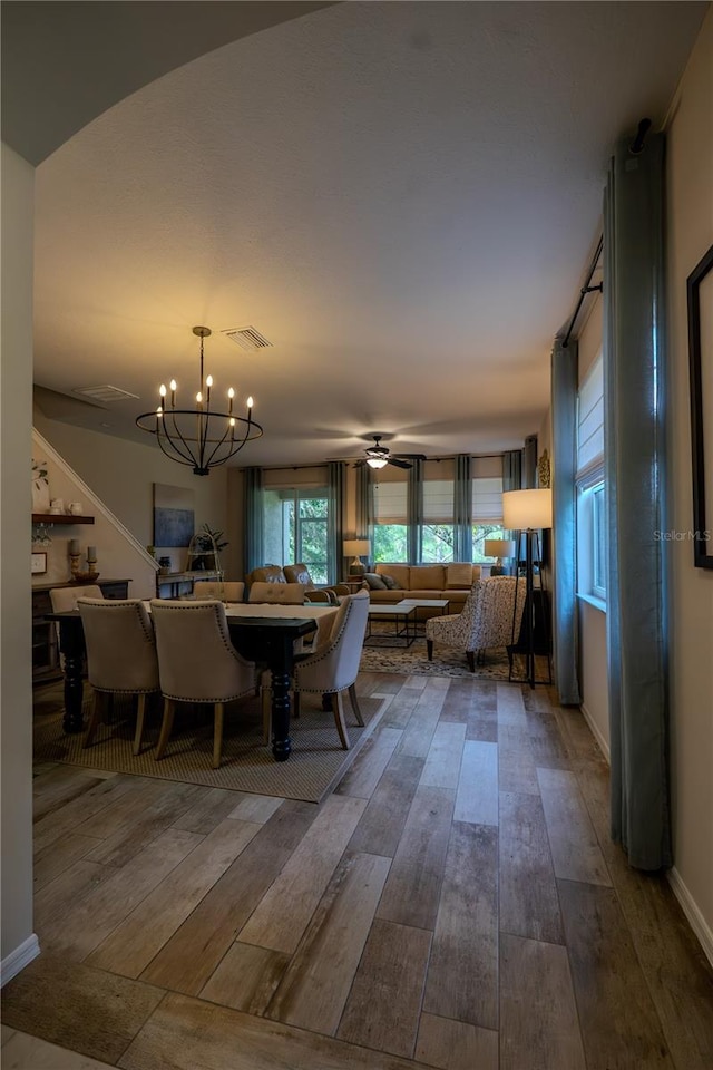 dining area featuring hardwood / wood-style floors, a chandelier, and ceiling fan