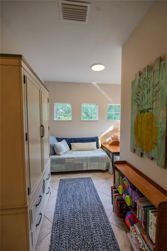 bedroom featuring light tile patterned flooring