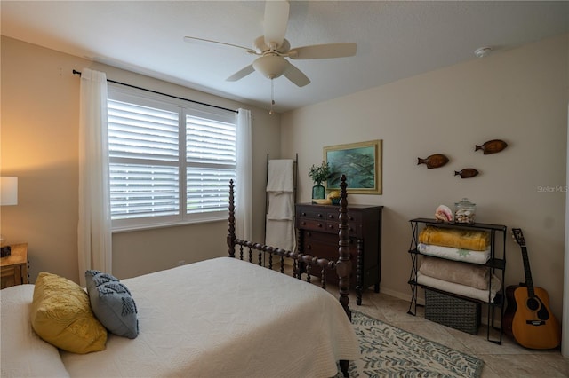 bedroom with a ceiling fan and tile patterned floors