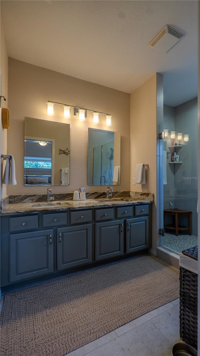full bath featuring a stall shower and double vanity