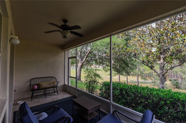 sunroom with a ceiling fan