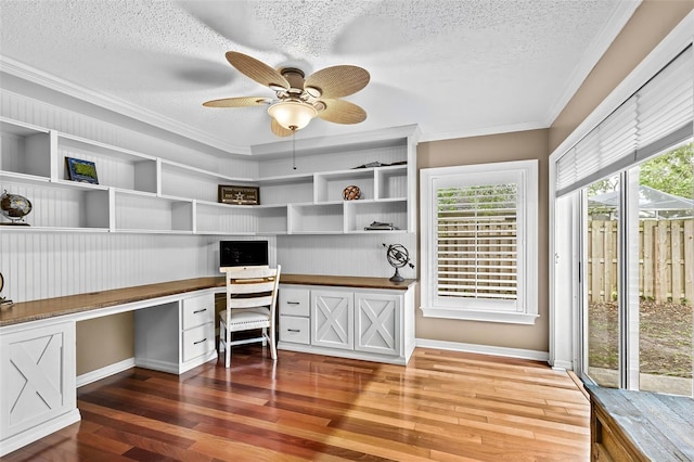 16804 Windsor Park Dr, Lutz, FL 33549 - unfurnished office featuring built in desk, a textured ceiling, wood-type flooring, crown molding, and baseboards