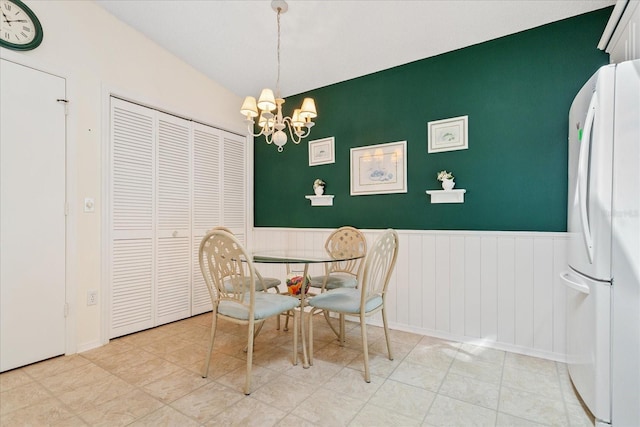 2121 Escobar Ave, Lady Lake, FL 32159 - dining space with wainscoting, a chandelier, and vaulted ceiling