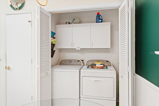 2121 Escobar Ave, Lady Lake, FL 32159 - laundry room with washer and dryer, cabinet space, and a wainscoted wall