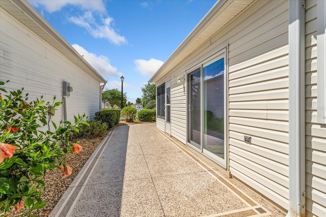 2121 Escobar Ave, Lady Lake, FL 32159 - view of side of home featuring a patio area
