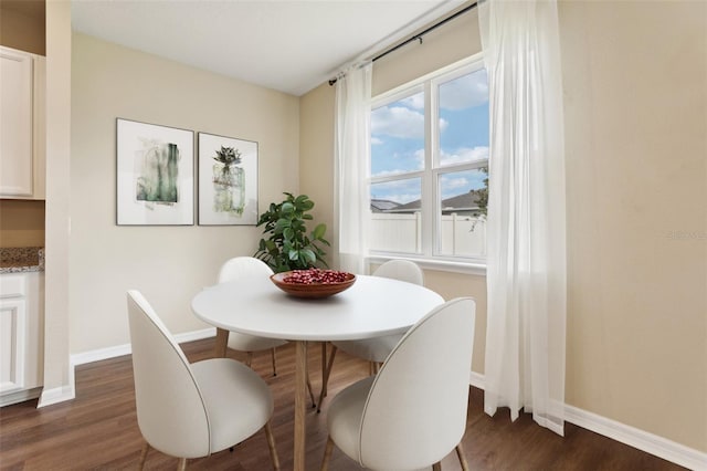 392 Summer Squall Rd, Davenport, FL 33837 - dining area featuring baseboards and dark wood-style floors