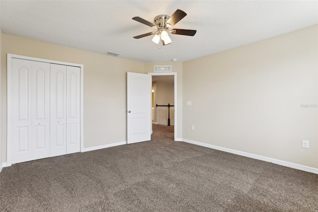 392 Summer Squall Rd, Davenport, FL 33837 - unfurnished bedroom with carpet flooring, a closet, baseboards, and ceiling fan
