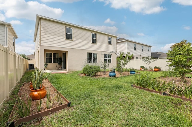 392 Summer Squall Rd, Davenport, FL 33837 - rear view of house featuring a vegetable garden, stucco siding, cooling unit, and a patio