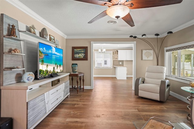 living area featuring ornamental molding, ceiling fan, dark wood-style flooring, and baseboards