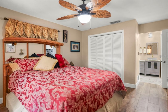 bedroom featuring wood finished floors, a closet, baseboards, and a ceiling fan