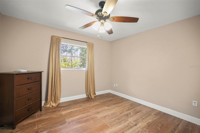 unfurnished bedroom with light wood-style floors, baseboards, and ceiling fan