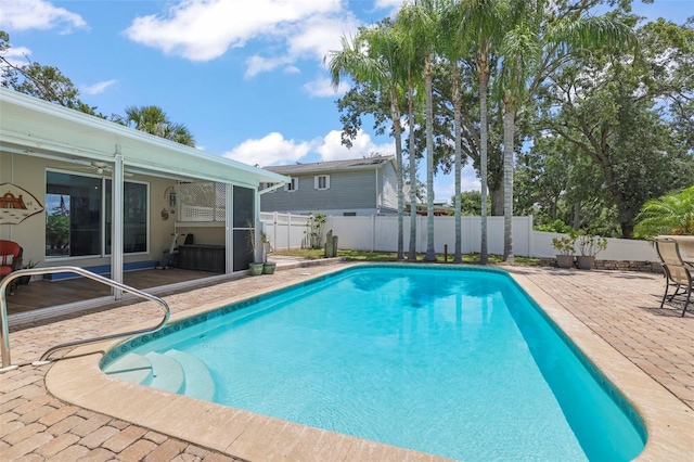 view of pool with a patio area, a fenced backyard, and a ceiling fan